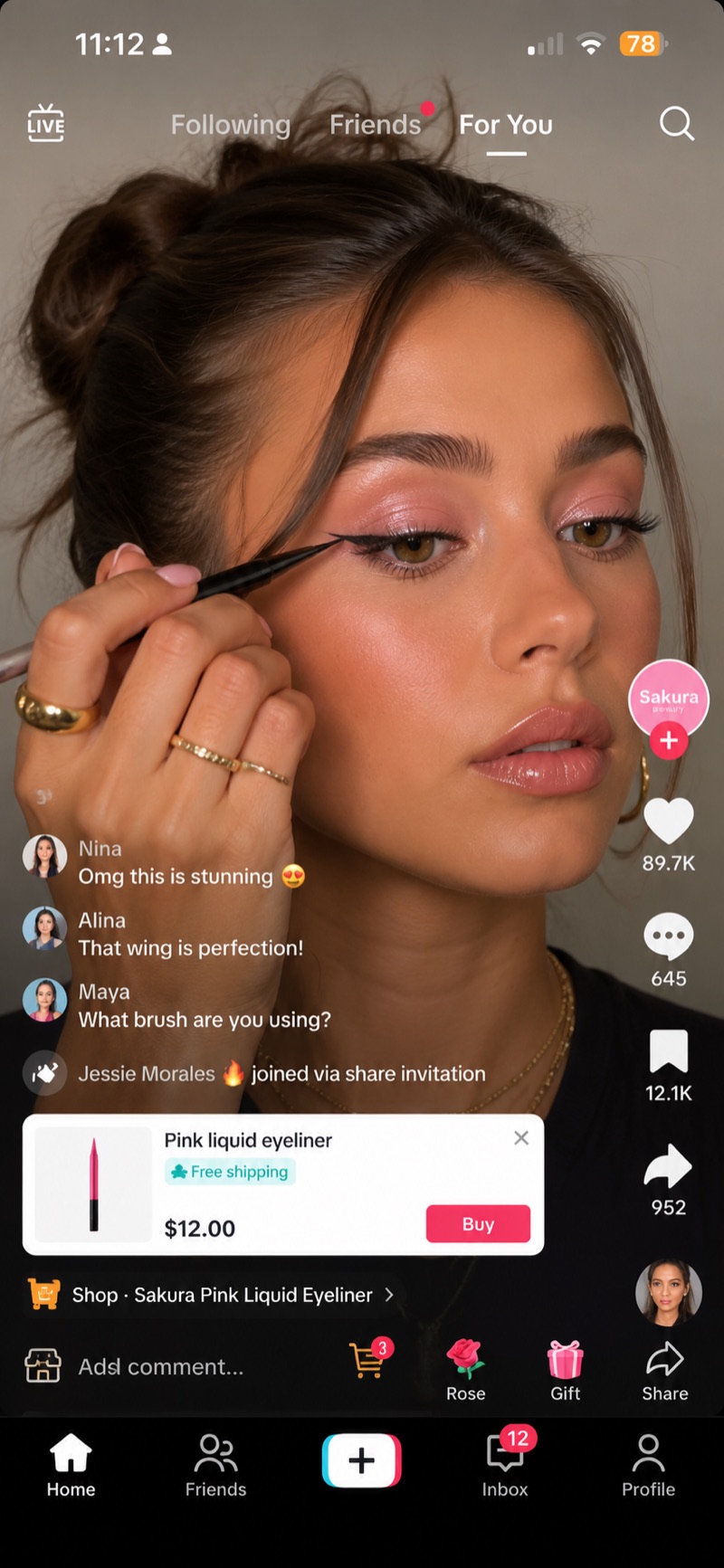 A creator drawing a winged line with Sakura pink liquid eyeliner, live comments running alongside