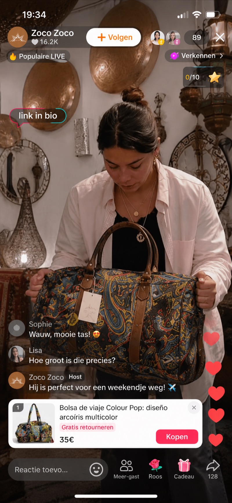 Zoco Zoco LIVE seller holding up a paisley print weekend travel bag